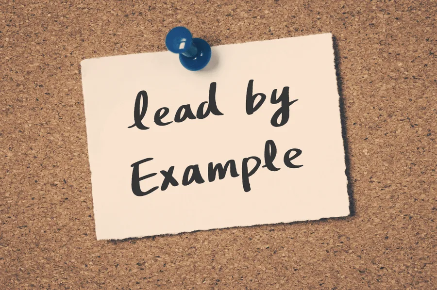 Note on a board saying lead by example